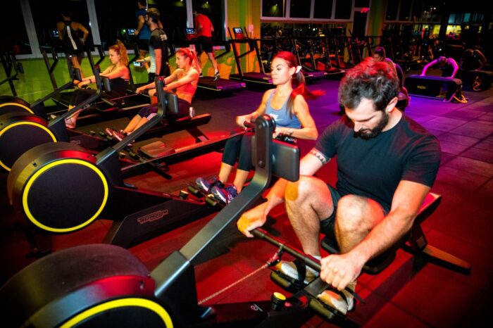 Group of people on rowing machines during cardio training in Ego Wellness gym.